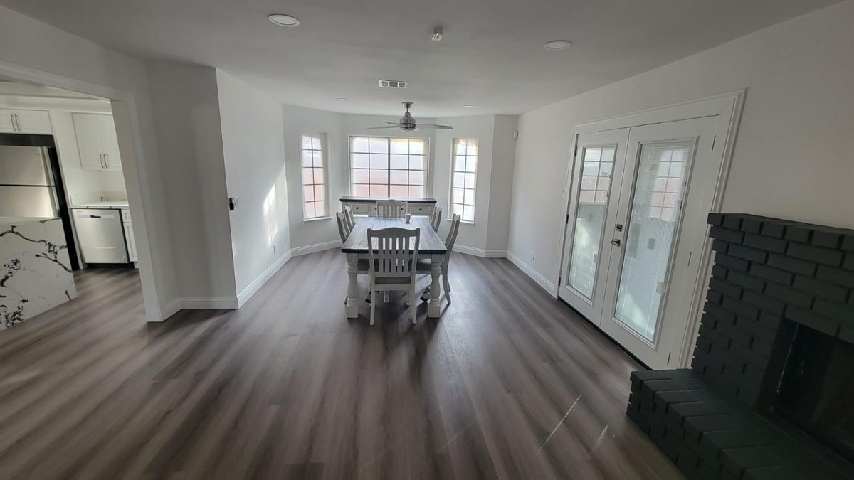 Modern grey LVP flooring installed in a Las Vegas dining room with fireplace